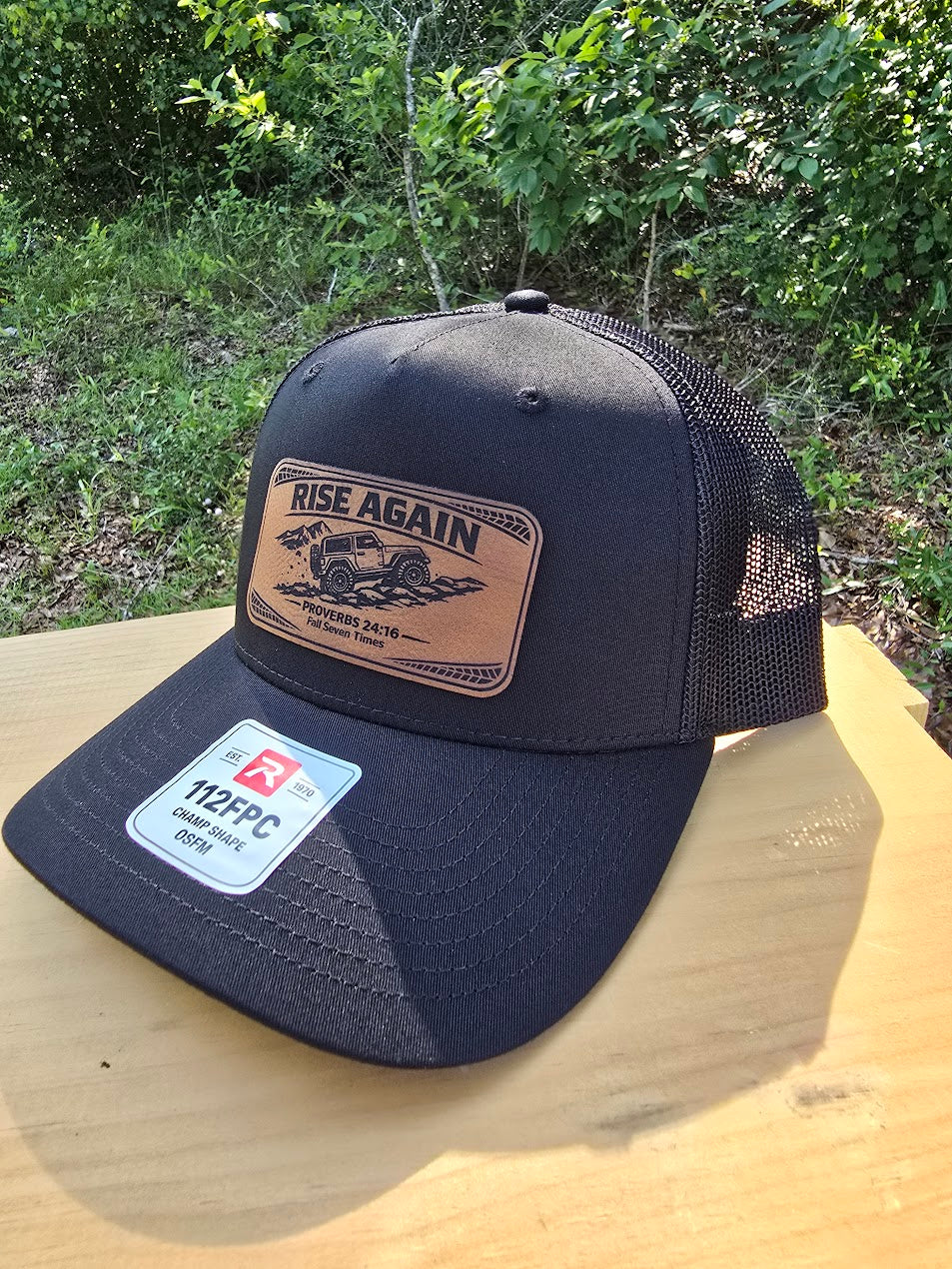 Rise Again | Proverbs 24:16 Leather Patch Trucker Hat